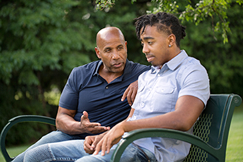 father talking to son