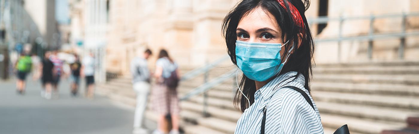 female student wearing mask on campus