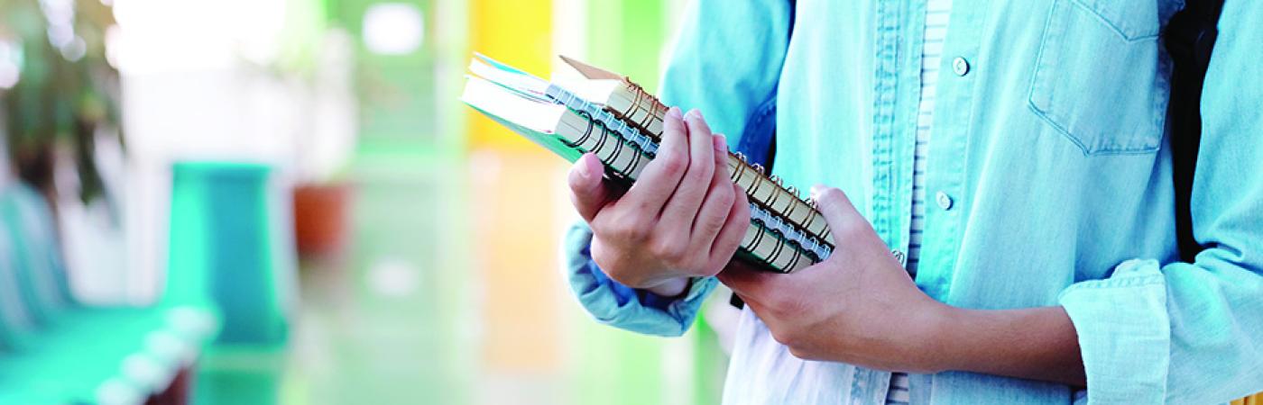 student holding books