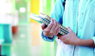 student holding books